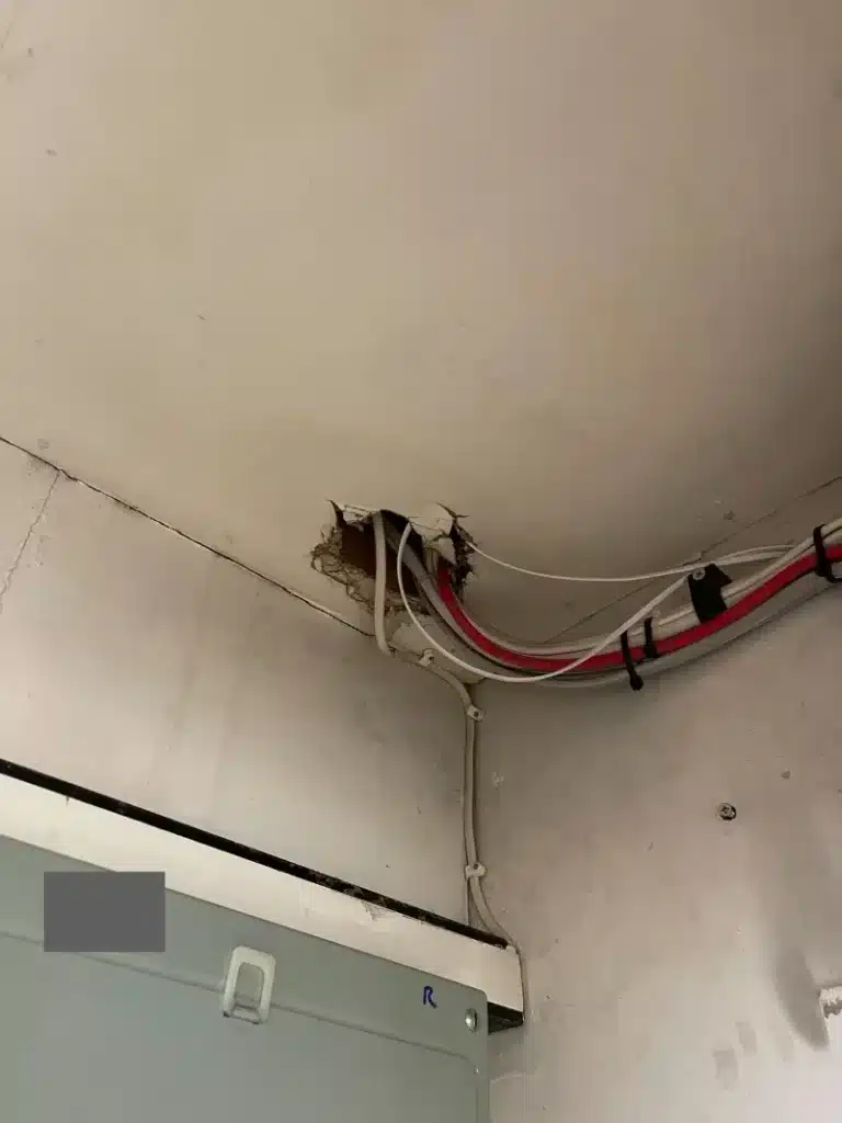 Cable penetration through the office ceiling lining.
